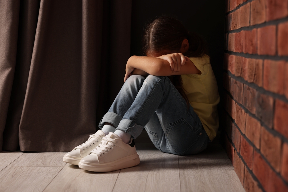 Child,Abuse.,Upset,Little,Girl,Sitting,On,Floor,Near,Brick How Substance Abuse Affects Child Custody Decisions in Alabama Courts